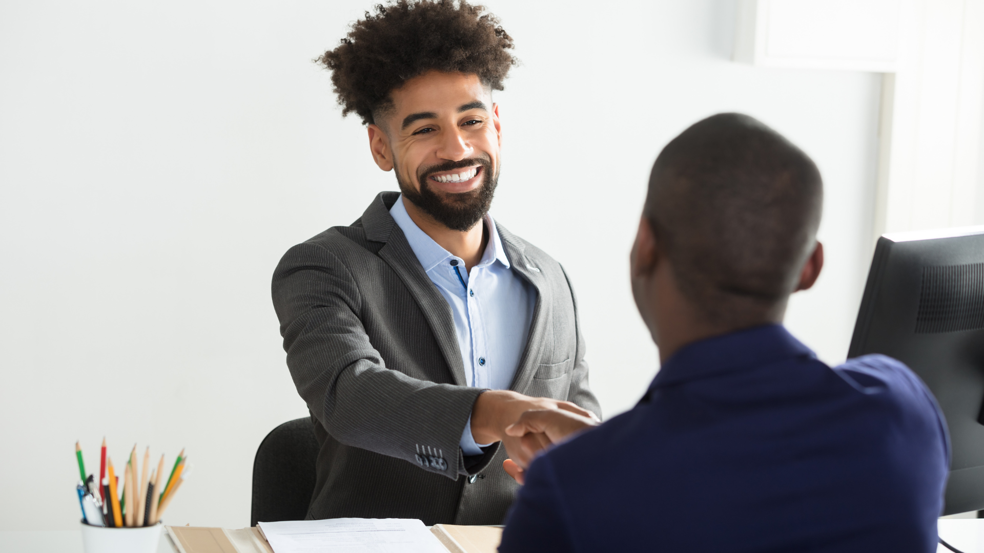 Wisconsin small business owner reviewing workers comp coverage with a PEO
